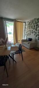 a living room with a couch and a table at Appartement de 46M2 in Chasseneuil-du-Poitou