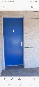 a blue door in front of a building at Appartement de 46M2 in Chasseneuil-du-Poitou