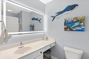 a white bathroom with a sink and a mirror at Waters Edge 606 - Oceanfront - Free Beach Service - Breathtaking Views in Fort Walton Beach +31 photos