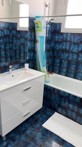 a bathroom with a white sink and a shower at La Parenthèse in Longchaumois +5 photos