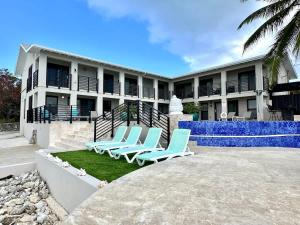a group of chairs sitting in front of a building at Seven Mile View Condo #4 in West Bay