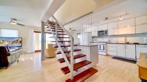 a kitchen with a spiral staircase in a house at Seven Mile View Condo #4 in West Bay