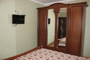 ノヴォミハイロフスキーにあるGostevoy Dom Comfortのベッドルーム(木製ドレッサー、鏡付)