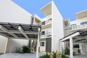 a view of a white apartment building with balconies at Allure #22 3BR Waterfront in Red Bay Estate
