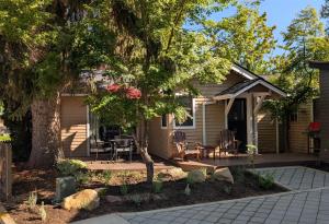 a house with a patio and a tree at Bluebird Day - River Gem Bungalow in Bend