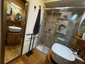 a bathroom with a shower and a sink and a toilet at Étoile des Alpes Studio in Limone Piemonte +15 photos