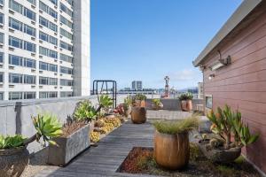 a walkway with potted plants on the side of a building at Tilden Hotel in San Francisco