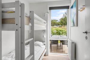 a small bedroom with bunk beds and a window at 0497-Romo-Vestergade-101-App-39 in Sønderby +29 photos