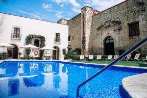 a swimming pool in front of a building at Quinta Real Oaxaca in Oaxaca City +170 photos