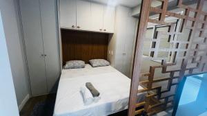 a small bedroom with a bunk bed and a ladder at Studio Guarulhos 208 in Guarulhos