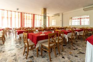 a dining room with tables and chairs with red table cloth at Hotel Paglierani - Nuova gestione 2024 in San Mauro a Mare