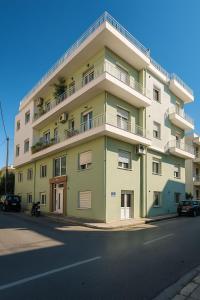a large apartment building on the side of a street at Your refuge overlooking port 6A in Mytilene
