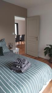 a bedroom with a bed with blue and white stripes at Maison de campagne in Périssac