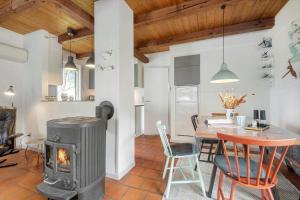 a living room with a wood stove and a table at 0162-Romo-Rabjergvej-97 in Kongsmark +14 photos