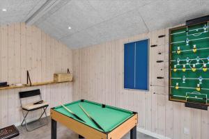een tafeltennistafel in een kamer met een bord bij 0308-Romo-Vagtelvej-4 in Mølby