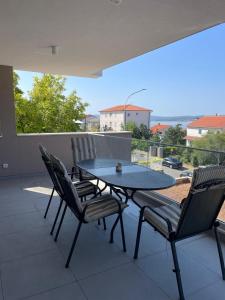 a table and chairs on a patio with a view at Villa Una in Crikvenica