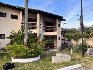 ein Haus mit einigen Pflanzen davor in der Unterkunft Condomínio Ouro – Piscina e Praia a Poucos Passos in Porto Seguro