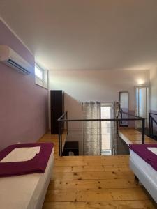 a room with two beds and a staircase at Emerald Palace in Florence