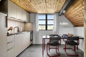a kitchen with a table and chairs in a room at 530-Lemvig-Lokkevej-59-D in Lemvig