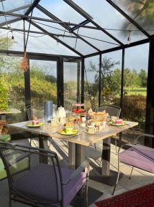 a table with food on it on a patio at B&B De Korenbloem in Noordbroek +18 photos