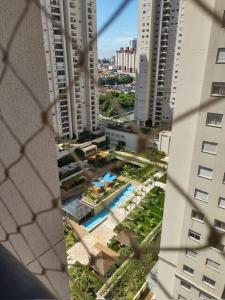 a view from a window of a building with a pool at 1505 studio guarulhos in Guarulhos