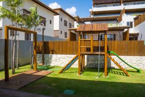 a playground with a swing set in a yard at Residencial Lanai Imbassai - Blue House - 102 in Mata de Sao Joao