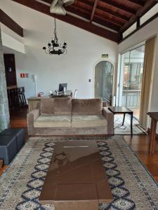 a living room with a couch and a table at Apartamento ao lado do Shopping Lamérica in Bento Gonçalves +53 photos