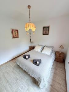 a bedroom with a bed with two hats on it at T3 façon Chalet, terrasse et garage privé, Villard-De-Lans in Villard-de-Lans