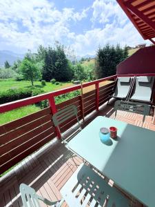 a patio with a table and chairs on a deck at T3 façon Chalet, terrasse et garage privé, Villard-De-Lans in Villard-de-Lans +8 photos