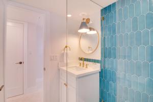 a bathroom with a sink and a blue tiled wall at Walk to Beach Tavernier Apartment with Patio! in Tavernier +16 photos
