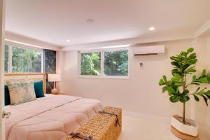 a bedroom with a large bed and a potted plant at Walk to Beach Tavernier Apartment with Patio! in Tavernier