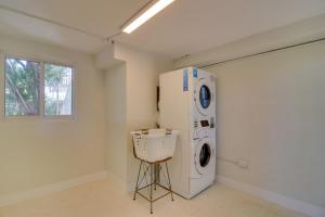 a laundry room with a washing machine and a window at Walk to Beach Tavernier Apartment with Patio! in Tavernier