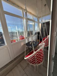 two hammocks on a balcony on a cruise ship at Apartament Bella in Craiova