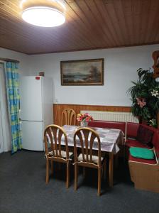 a kitchen with a table and chairs and a refrigerator at Penzion furovi in Ostrov