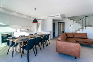 a living room with a couch and a table and chairs at Luxury House at El Mirador Wellness, Hus 21 in Torrox Costa