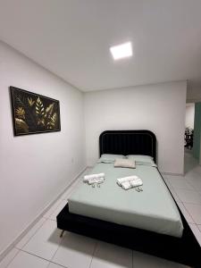 a bedroom with a bed in a white room at Edificio Artur Regis in Petrolina
