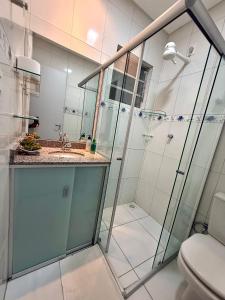 a bathroom with a shower and a sink and a toilet at Edificio Artur Regis in Petrolina +29 photos