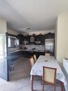 a kitchen with a table and chairs in a room at Villa Athamanio - Premium in Athamanio +1 photo