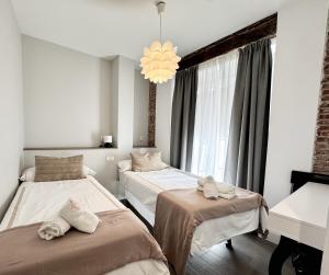 Katil atau katil-katil dalam bilik di Apartamentos DUKE