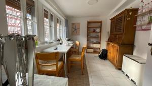 a kitchen with a table and a refrigerator at Haus im Herzen von Homberg in Niederdorla