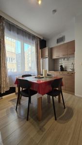 a kitchen with a table and two chairs and a kitchen with at Royal sleeping Brussels in Brussels +12 photos