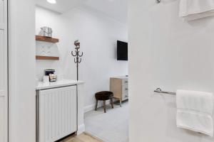 a bathroom with white walls and a sink and a stool at The Charter at Beaver Creek E135 in Beaver Creek