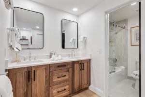 a bathroom with a sink and two mirrors at The Charter at Beaver Creek E135 in Beaver Creek