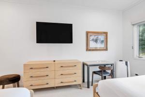 a bedroom with a dresser and a tv on a wall at The Charter at Beaver Creek E135 in Beaver Creek