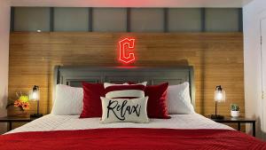 a bedroom with a bed with a neon sign above it at Downtown Cleveland- Steps to Sports & Events condo in Cleveland