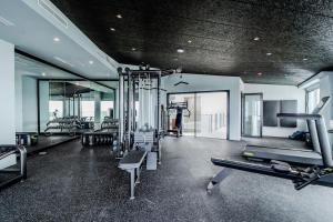 a gym with treadmills and machines in a room at Luxury House in El Mirador Calaceite Torrox Costa, Hus 19 in Torrox Costa
