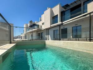 a swimming pool in front of a building at Luxury House in El Mirador Calaceite Torrox Costa, Hus 19 in Torrox Costa +30 photos