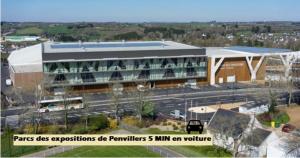 a large building with a parking lot in front of it at Cosy logement Hyper Centre-ville in Quimper