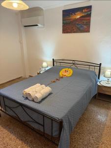 a bedroom with a bed with towels on it at Beautiful and Remodeled Apartment 1A in Mytilini