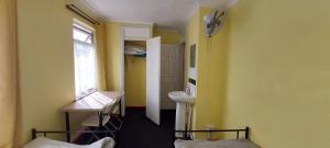 a room with yellow walls and a sink and a window at Linda 5BR House Of Basildon in Basildon +64 photos